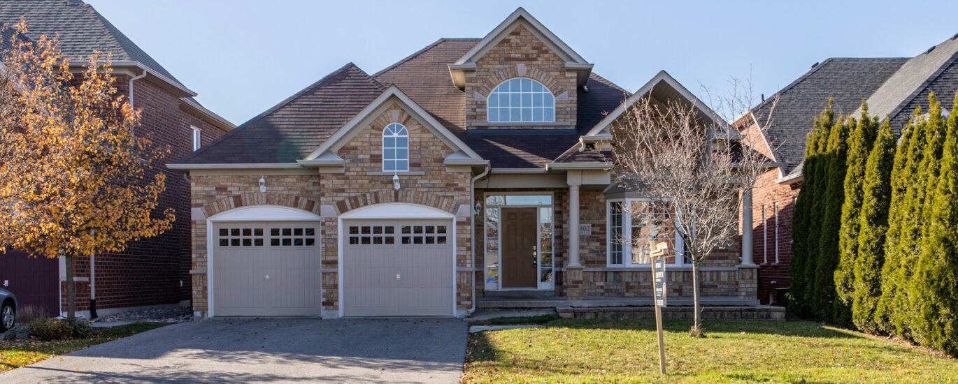 brown and white concrete house under blue sky during daytime